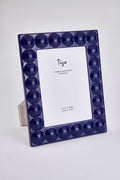 Navy blue photo frame with round cutouts on a white background