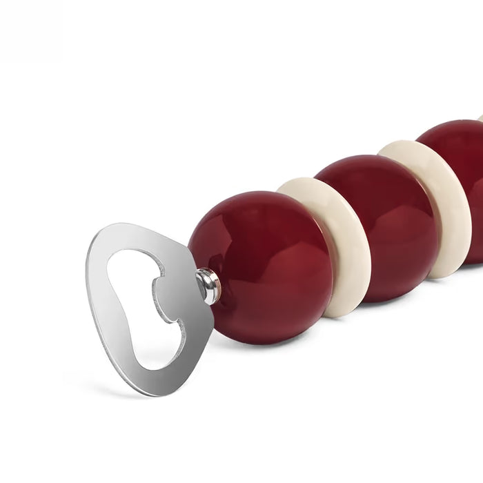 Red and white striped bottle opener on a white background