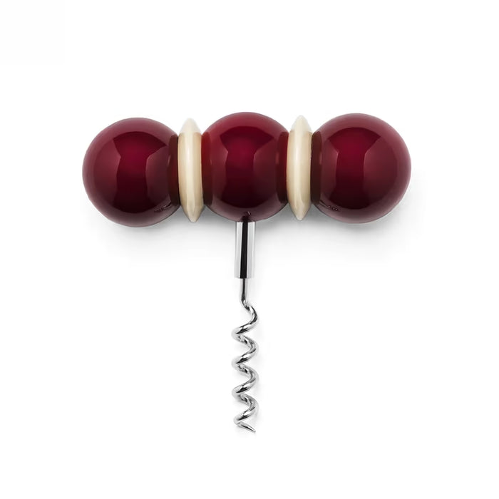 Corkscrew with red and white beads on a white background