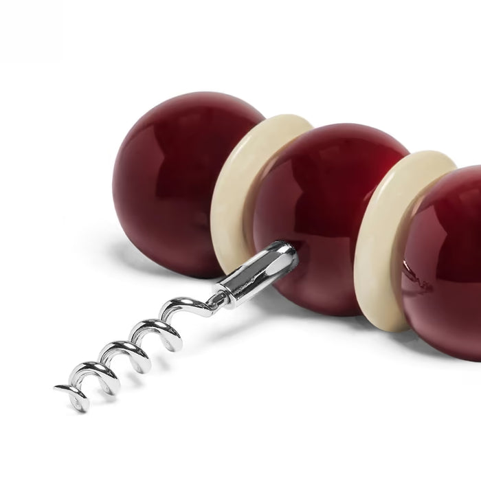 Corkscrew with red and beige handle on a white background