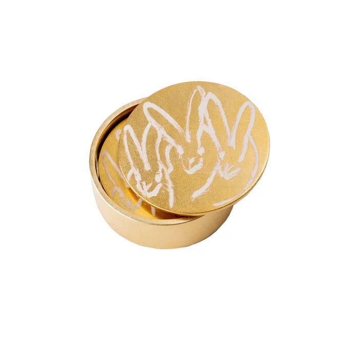 Gold circular container with white rabbit design on a white background