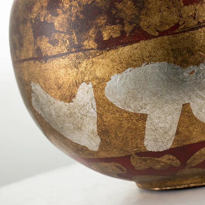 Decorative bowl with gold and red patterns on a white background