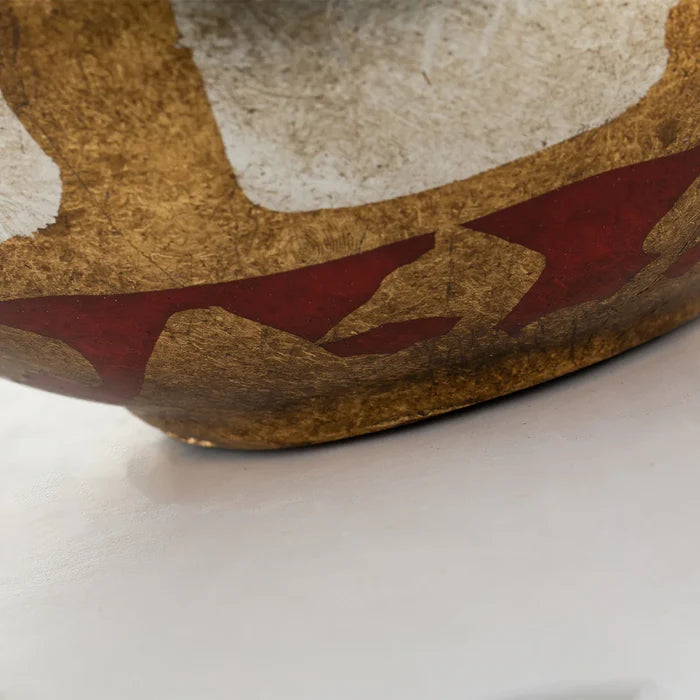 Close-up of a decorative bowl with brown, beige, and red colors on a white background