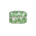 Decorative box with green floral and architectural design on a white background