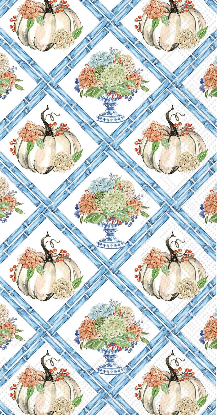 A repeating autumn-themed pattern featuring white pumpkins with orange flowers, blue floral urns, and a blue lattice grid on a white background.