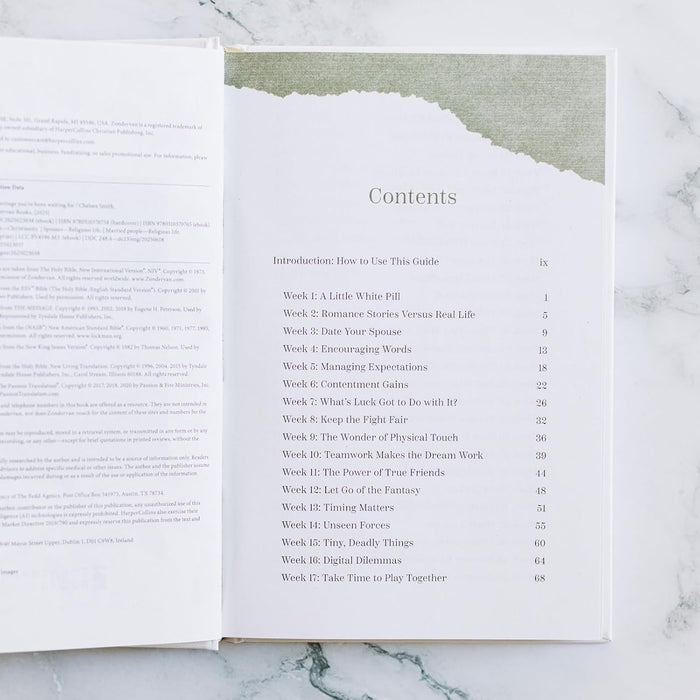 Open book showing a table of contents on a marble surface