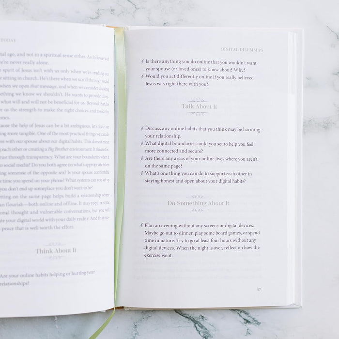 Open book with printed text on a marble surface