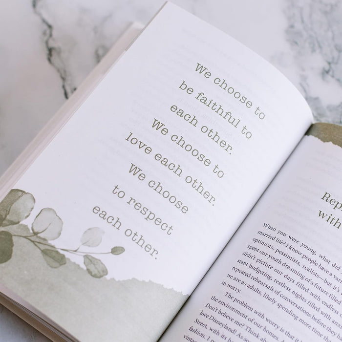 Open book with inspirational text on a marble surface