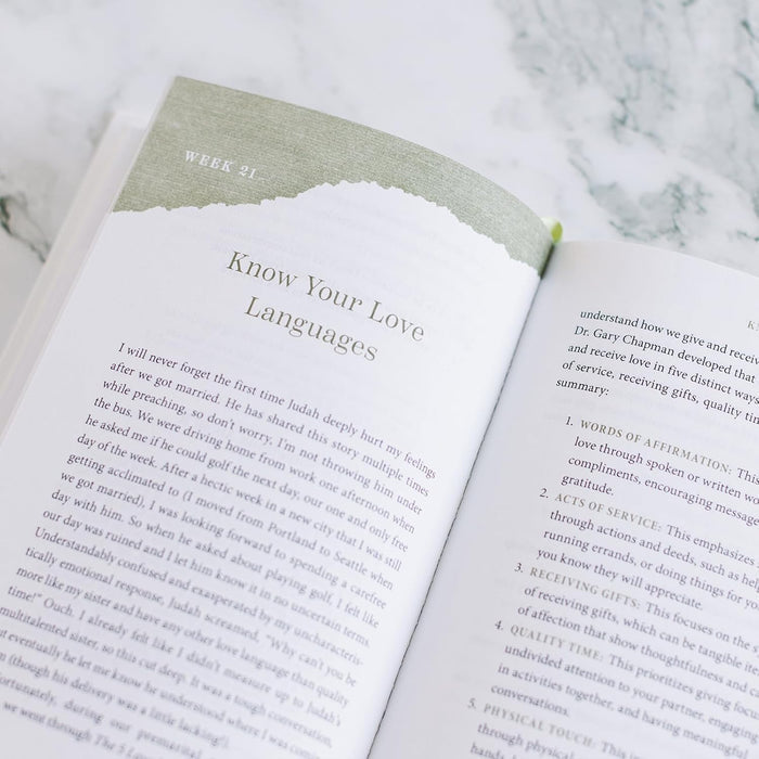 Open book on a marble surface with text about love languages
