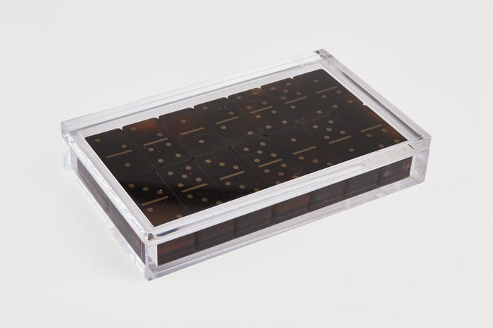Clear plastic container with dark brown items on a light gray background