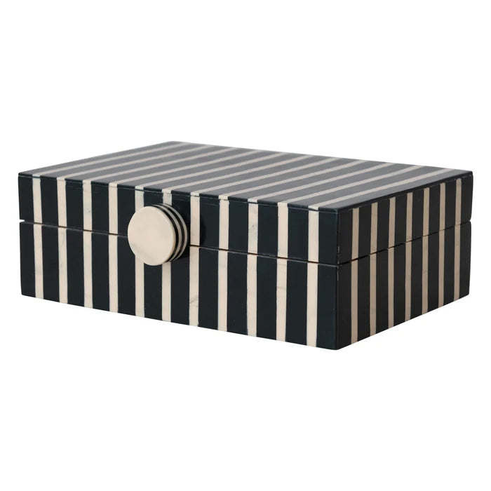 Striped jewelry box with a metallic clasp on a white background