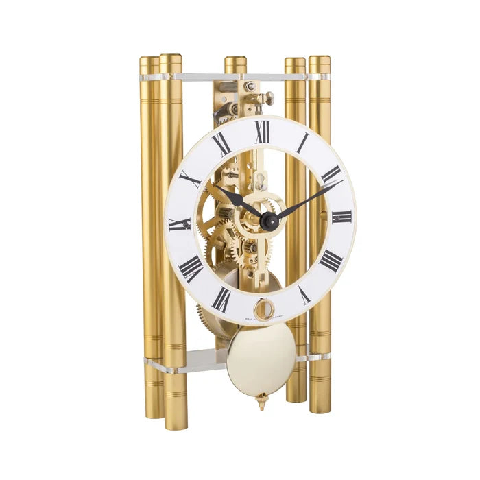 Decorative clock with gold cylindrical design on a white background