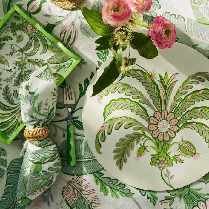Decorative table setting with floral and leaf patterns on plates and napkins.