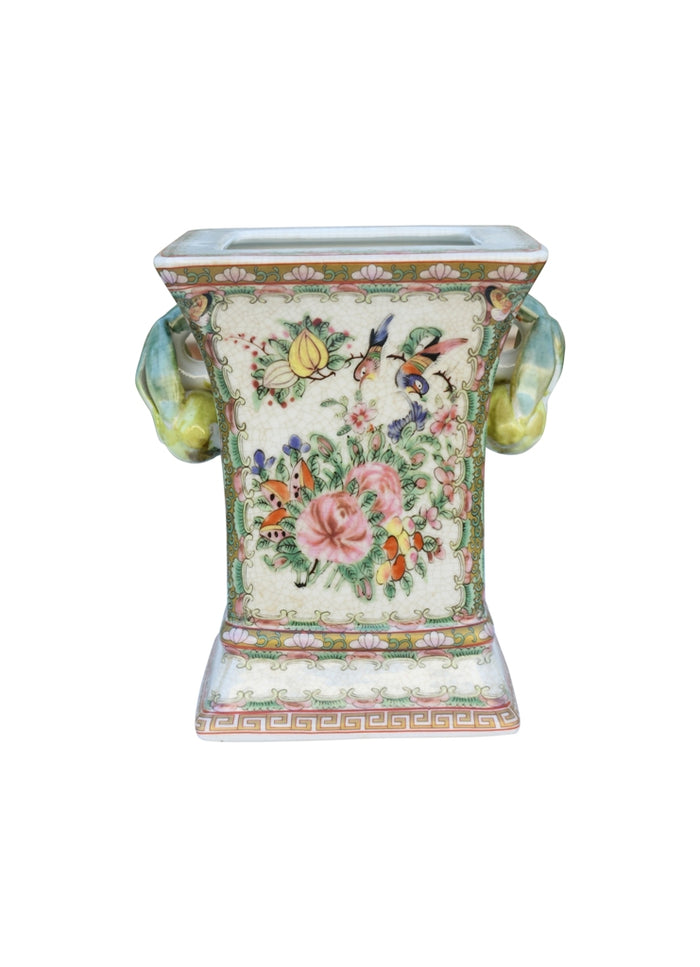 Decorative ceramic vase with floral and butterfly design on a white background