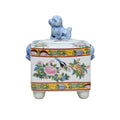 Decorative ceramic box with floral patterns and a small dog figurine on top