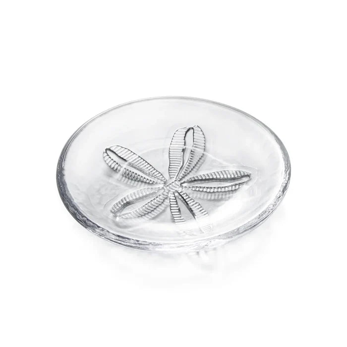 Clear glass dish with sand dollar design on a white background