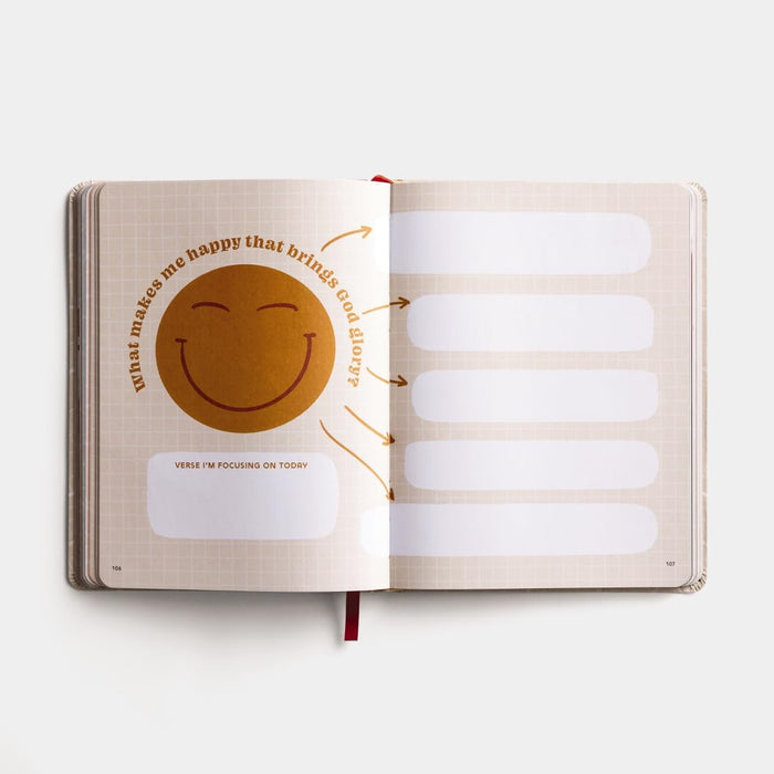 Open notebook with a smiley face and text on a white background