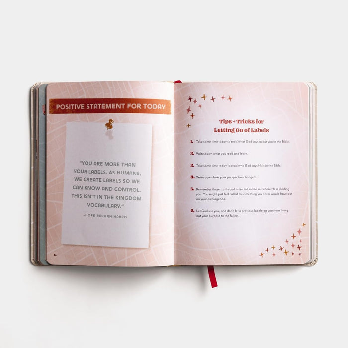 Open book with inspirational text on a white background