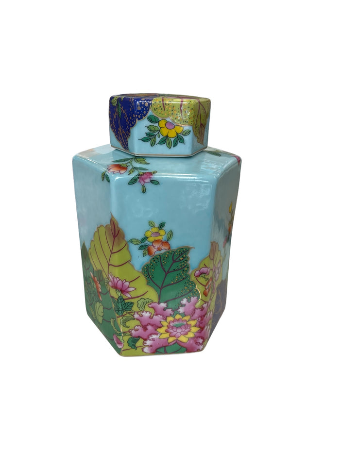 Decorative turquoise porcelain jar with Tobacco Leaf patterns on a white background